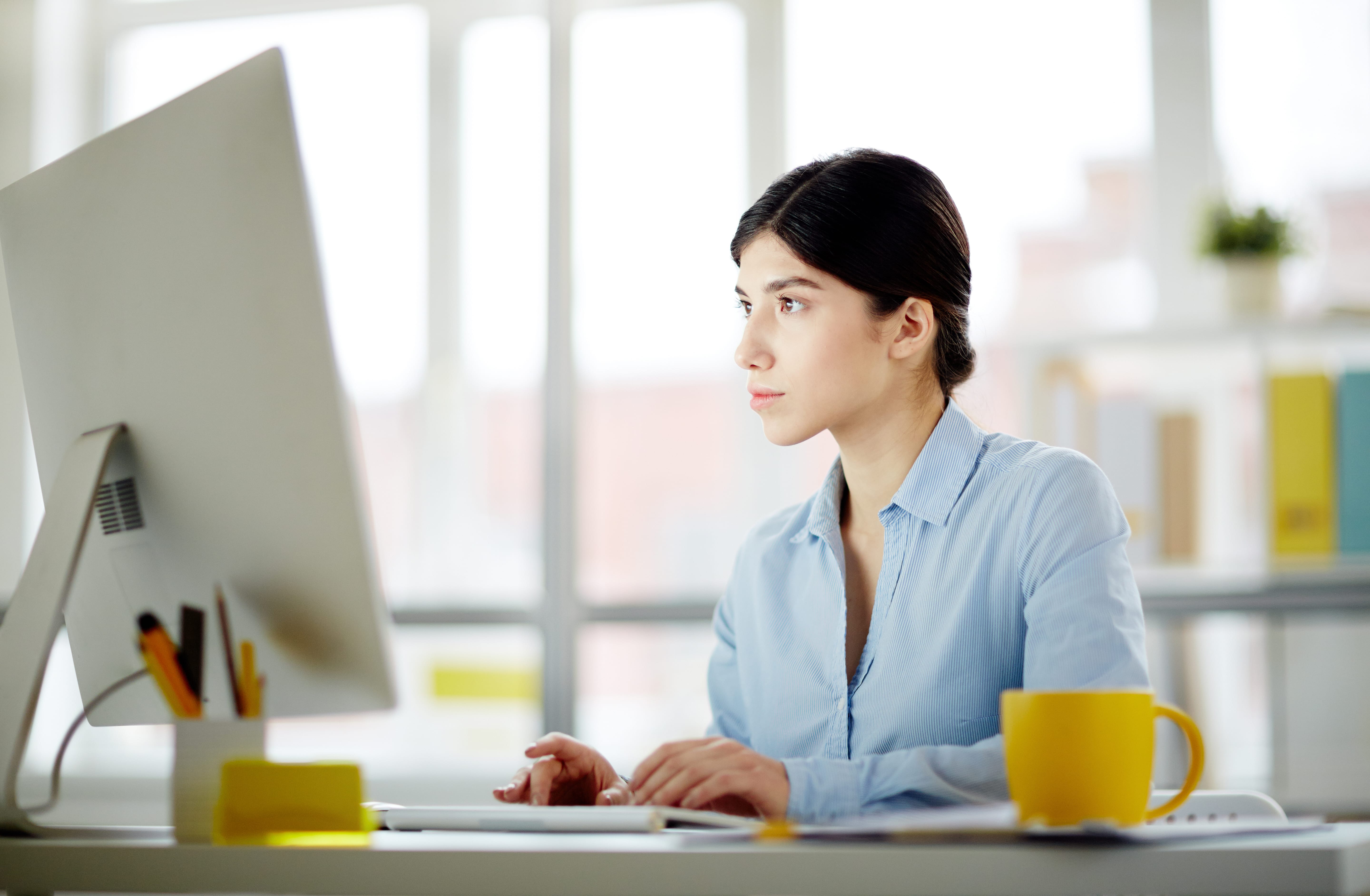 Businesswoman typing on laptop