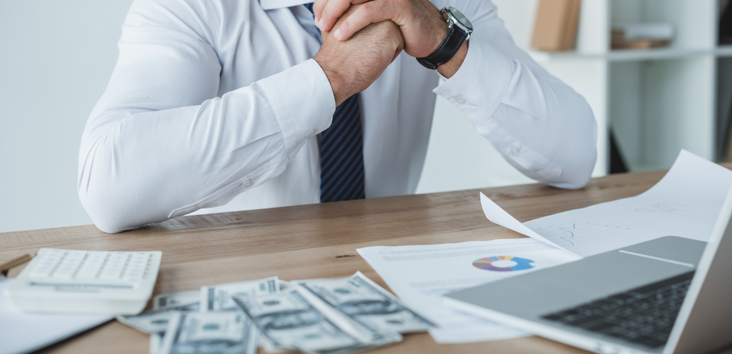 Business man sitting at desk with Investing Options