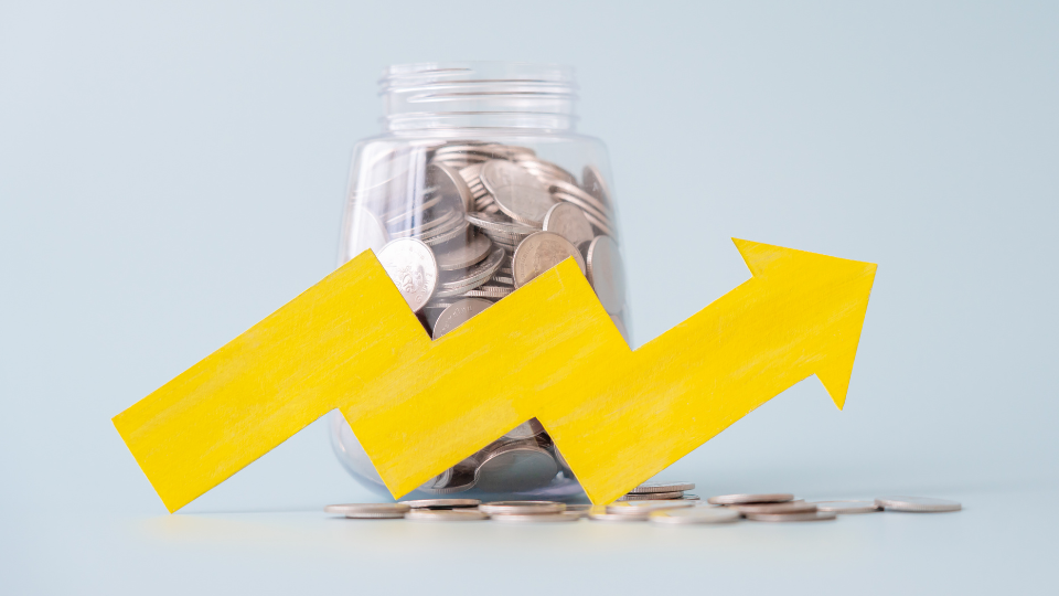 Yellow arrow pointing upward over jar of coins