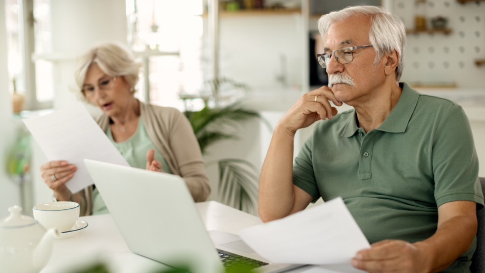 Elderly couple reviewing documents