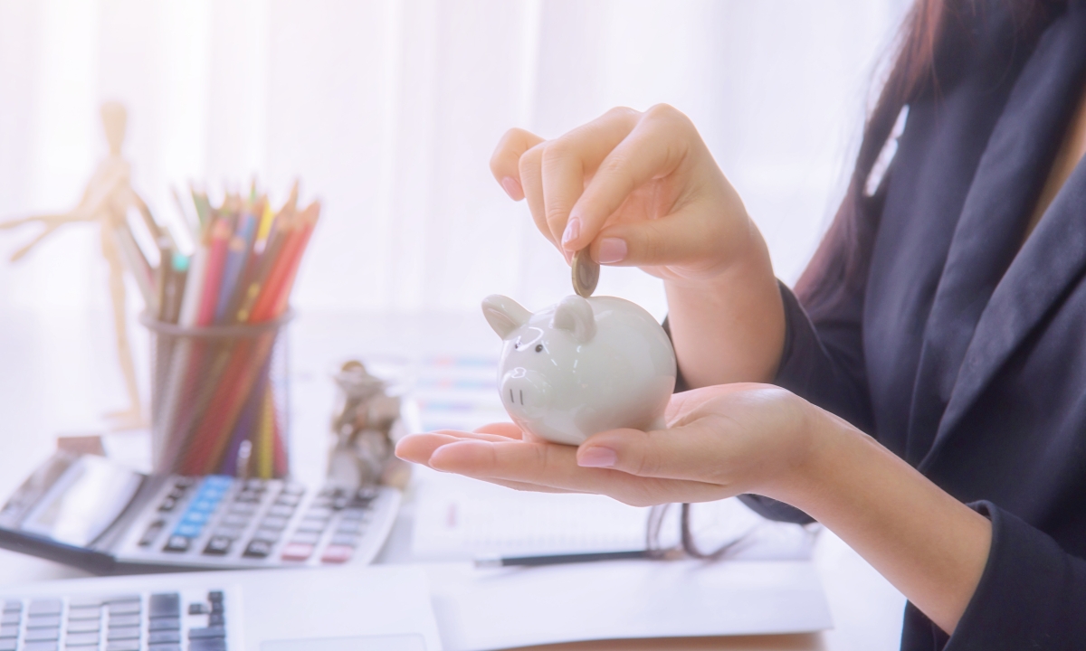 Hands holding a piggy bank
